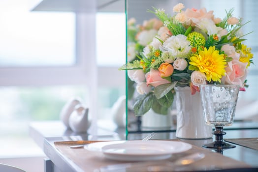 Colorful rose flower in vase on dinning table photo