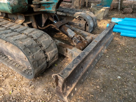 The metal blade of the small excavation for grader the soil from digging and laying water pipes. photo