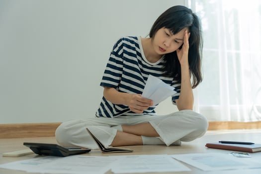 Stressed and headache asian woman with large bills or invoices no money to pay to expenses and credit card debt. shortage, Financial problems, mortgage, loan, bankruptcy, bankrupt, poor, empty wallet photo