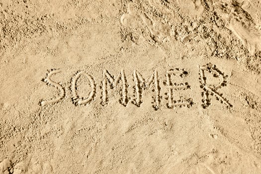 Summer in German - Word on Sand photo