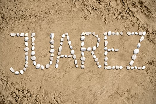 Juarez - Word Made with Stones on Sand photo