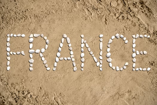 France - Word Made with Stones on Sand photo