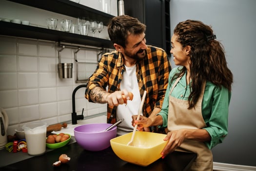 Happy multiethnic couple cooking together photo
