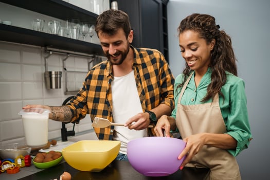 Happy multiethnic couple cooking together photo
