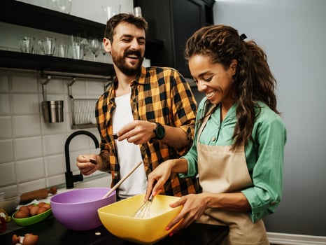 Happy multiethnic couple cooking together photo