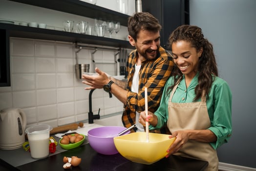 Happy multiethnic couple cooking together photo