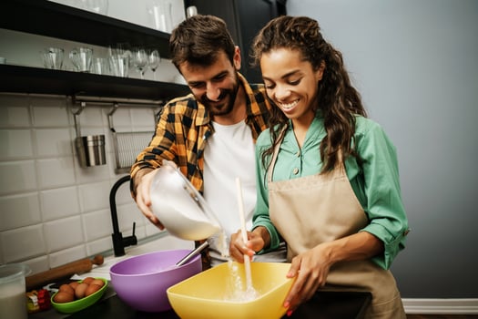 Happy multiethnic couple cooking together photo
