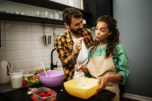 Happy multiethnic couple cooking together photo