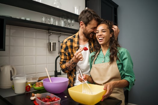 Happy multiethnic couple cooking together photo