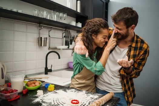 Happy multiethnic couple cooking together photo