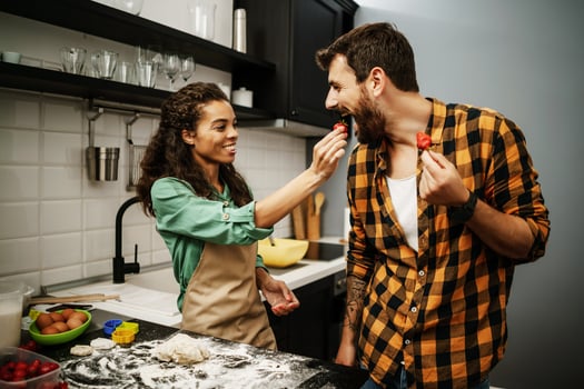 Happy multiethnic couple cooking together photo