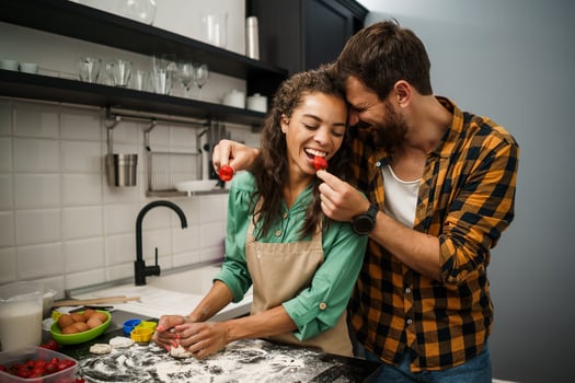 Happy multiethnic couple cooking together photo