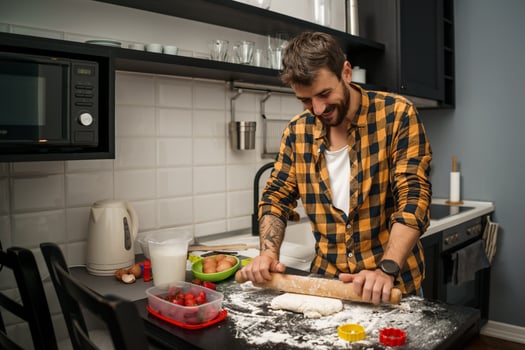 A man baking cookies in the kitchen photo