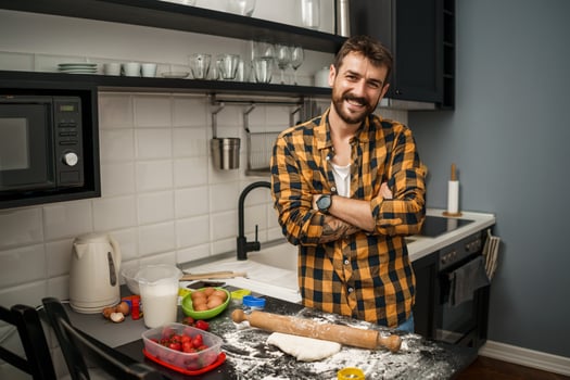 A man baking cookies in the kitchen photo