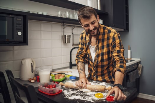 A man baking cookies in the kitchen photo