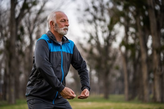 A senior man doing physical exercises photo