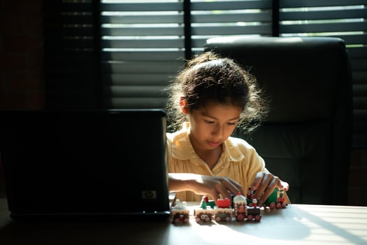Portrait of little girl in the office room of house, They are having fun playing with toy trains photo