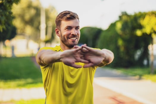 A man in a yellow t-shirt doing physical exercises photo