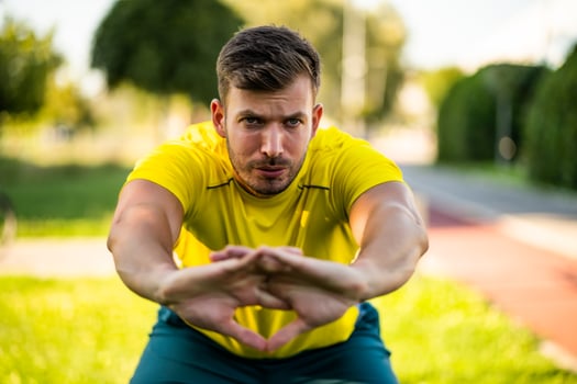 A man in a yellow t-shirt doing physical exercises photo