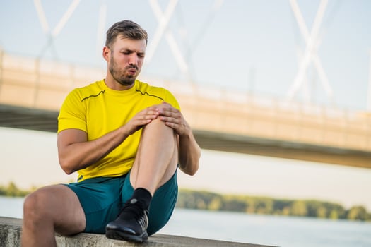 A man in a yellow t-shirt doing physical exercises photo