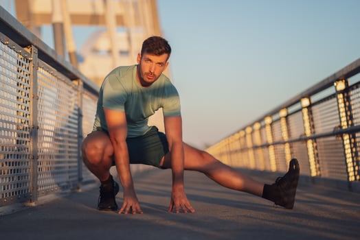 A man in a green t-shirt doing exercises photo