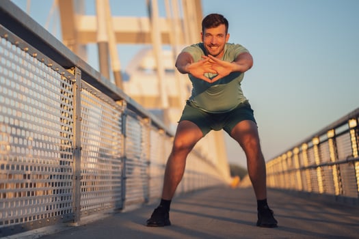 A man in a green t-shirt doing exercises photo