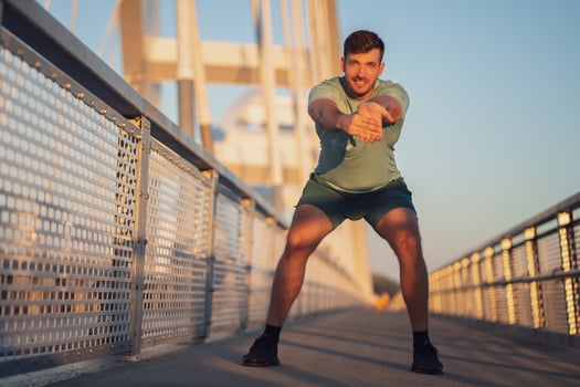 A man in a green t-shirt doing exercises photo