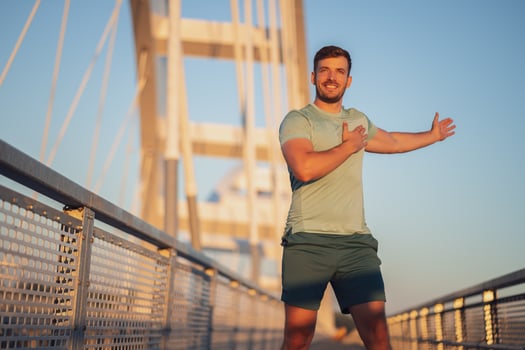 A man in a green t-shirt doing exercises photo
