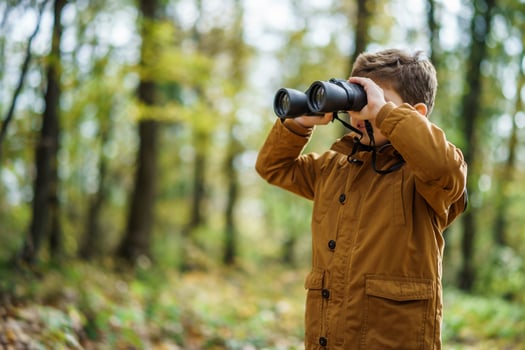 Young boy with binoculars photo