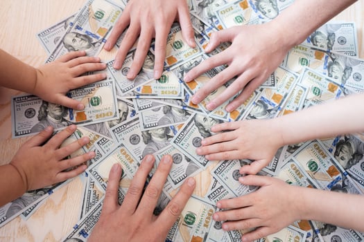 Kids hands on dollar money. Distribution of family property. photo