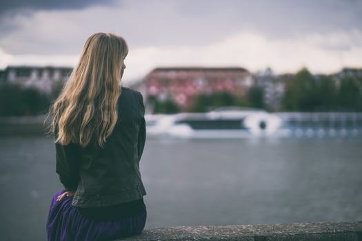 A young woman alone by a bridge photo