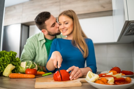A young couple cooking together photo