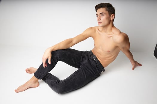 Man sitting on the floor naked torso casual wear isolated background photo