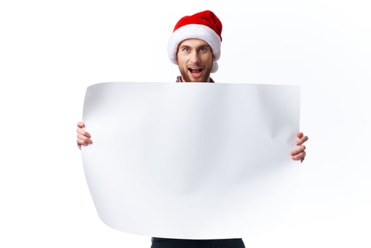 emotional man in a christmas hat with white mockup poster christmas isolated background photo