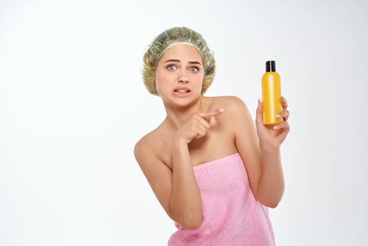 woman with bare shoulders and facial lotion photo