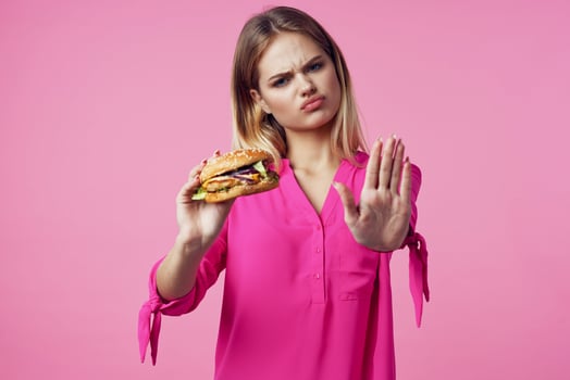 cute cheerful woman in pink shirt hamburger food diet photo