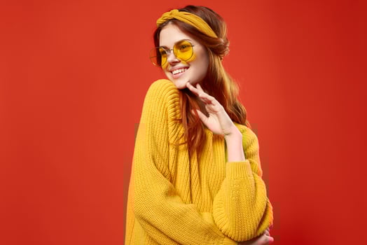 cheerful woman in yellow glasses sweater hipster fashion retro style photo