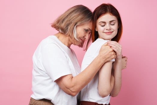 Mom and daughter in white t-shirts hug together family friendship photo
