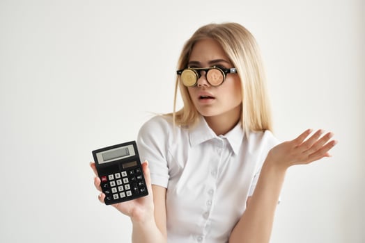 pretty woman calculator in hand and bitcoin light background photo