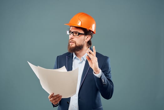 Emotional man in orange coloring drawings instruction manual construction work photo