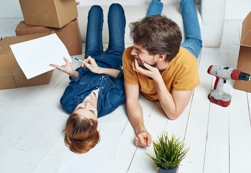 man and woman on the floor with boxes planning moving to apartment photo