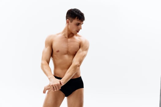 athletic male athlete with a pumped-up body in dark shorts bodybuilder photo