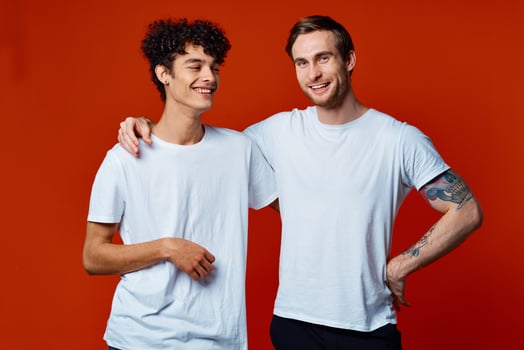funny two friends in white t-shirts posing Studio photo
