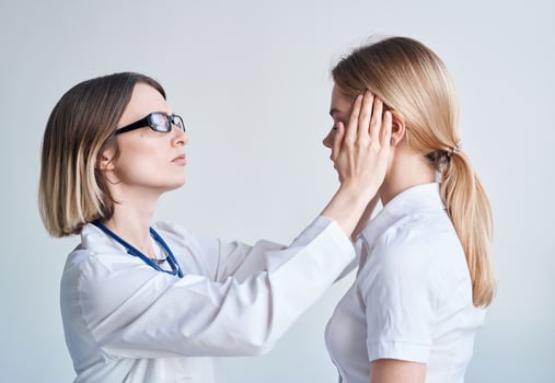 Doctor and patient on light blue background stethoscope health problems cropped view photo