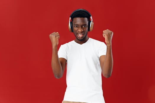 man of African appearance in headphones music red background photo