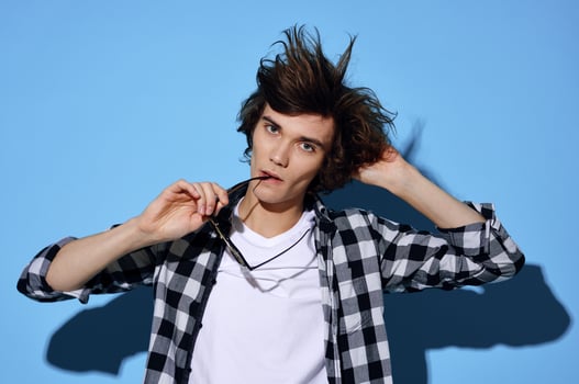 guy in plaid shirt tousled hair glasses fashion posing photo