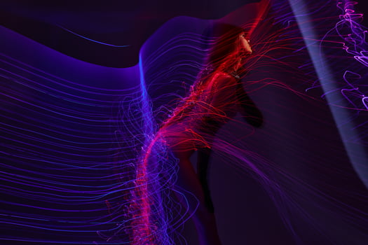 Positive young woman neon lines posing model glamor color background unaltered photo