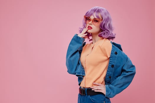 Pretty young female denim clothing fashion posing cap pink glasses color background unaltered photo