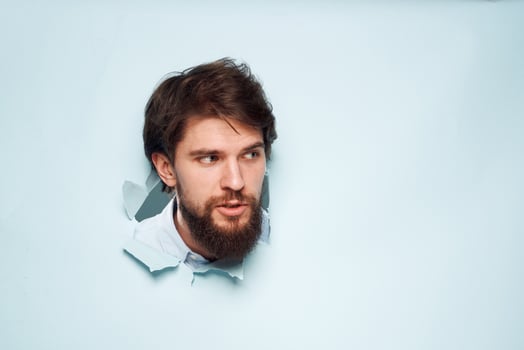 A man's head peeps out from behind a wall of emotion job career discontent photo
