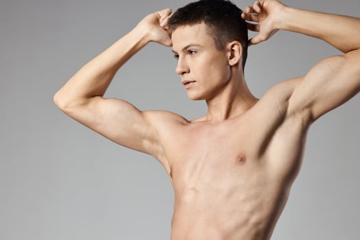 the guy holds his hands behind his head Sport Fitness pumped up muscles bodybuilder photo